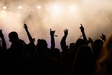 Abstract photo of crowd at concert and blurred stage lights.