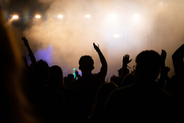 Abstract photo of crowd at concert and blurred stage lights.