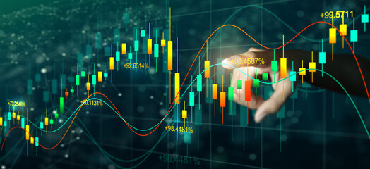 Double exposure of Business man hand on digital stock market financial indicator with night city...