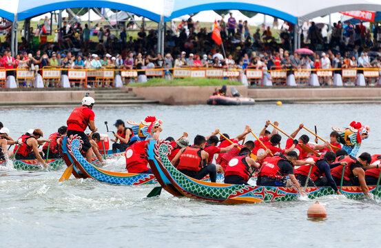 A competitive racing on Keelung River, where the women athletes pull vigorously on the oars to the pace of the drumbeats by the team leaders, in the traditional Dragon Boat Festival in Taipei, Taiwan