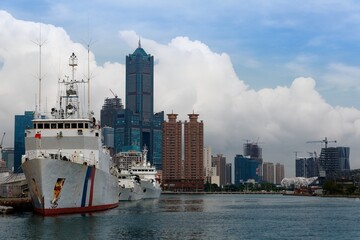 Patrol ships of Coast Guard Administration anchored in Kaohsiung Harbor and the famous landmark 85...