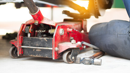 Mechanic using wrench while working on car engine at garage workshop, Car auto services and...