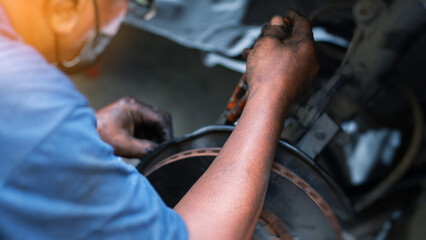 Mechanic using wrench while working on car engine at garage workshop, Car auto services and...