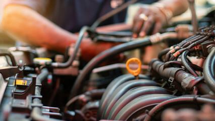 Mechanic using wrench while working on car engine at garage workshop, Car auto services and...