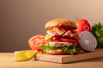 Fresh tasty burger on a wooden cutting board.