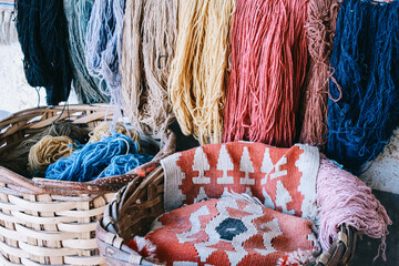 Colorful skeins of silk thread to create traditional Turkish carpet on a loom.