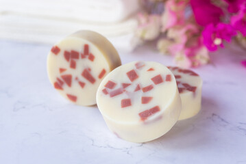 handmade natural soap bars, handmade rose clay soap on white background with pink flowers.