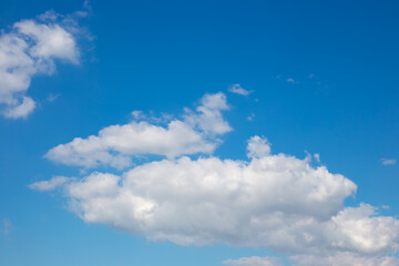 Naklejka na ściany i meble White clouds on a blue sky. Sky background