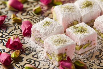 Delicate rosewater-infused Turkish delight, elegantly dusted with powdered sugar and pistachio crumbs, set against a backdrop of intricate arabesque p