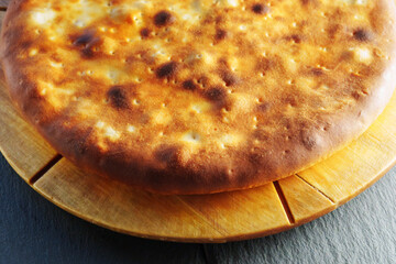 Golden Crisped pie on Wooden Board, close up, macro
