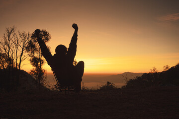 landscape and travel concept with solo freelancer man sit on chair and see sunrise with layer of...
