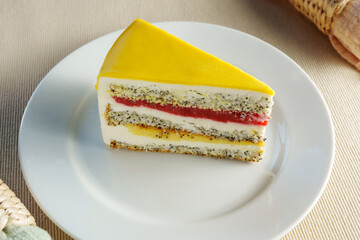 Delicious Delight: A Tempting Slice of Cake Resting on a Gleaming White Plate