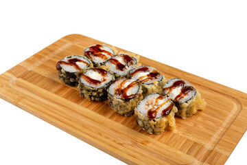 Japanese sushi roll fried with teriyaki sauce with shrimp on a wooden board, isolated.