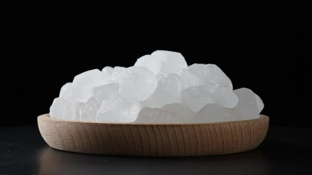 white sugar rock candy clsue up on black background.