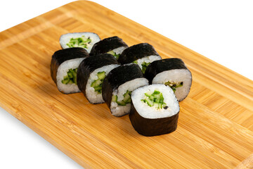 Kappa maki with cucumber on a wooden board, isolated.