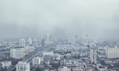 Danger from PM 2.5 airborne dust in the city. The weather is covered with toxic smog. Urban air...
