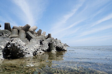 concrete tetrapod breakwater stones are stacked to prevent abrasion