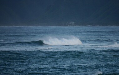 Dark blue ocean wave in the distance