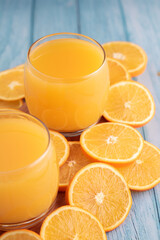 photograph featuring a glass of fresh orange juice. fruit, and liquid