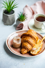 Tasty breakfast with croissant and honey