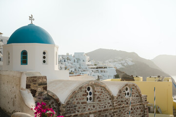 Blue dome church and the Oia village cityscape in Santorini