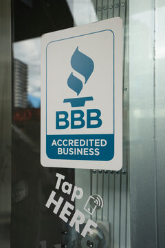 Vancouver, BC, Canada - Dec 22, 2023:  BBB Accredited Business sign is seen at the entrance to a currency exchange store. Better Business Bureau (BBB) focuses on advancing marketplace trust.