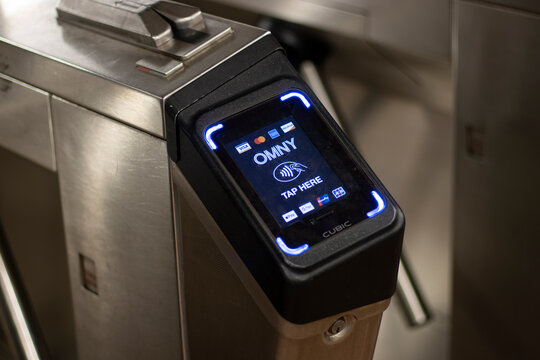 New York, NY, USA - July 5, 2022: An OMNY reader is seen at a subway turnstile in New York City. OMNY readers are contactless point-of-sale terminals that allow passengers to pay their fare instantly.