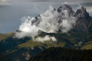 Summer mist over the three peaks of the Sassolungo (Langkofel) in the Dolomites, Italy.