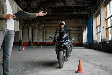 Student learning how to drive motorcycle with one hand