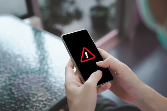 Alert message mobile notification, Emergency alert, Data network protection, Virus alarm, Wireless technology concept. Person using mobile smartphone and recieve warning alert show on screen.