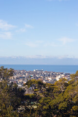 Obraz premium Looking to the city of Hikone from Hikonejo (Hikone Castle) in morning in Winter, Shiga Prefecture, Japan. Vertical image