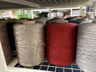 Rolls of thread for sewing on a shelf in a textile shop