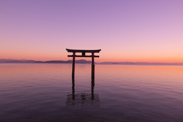 Beautiful dusk of a grand torii gate at Lake Biwa (Biwako), Takashima, Shiga, Japan. Silhouette....