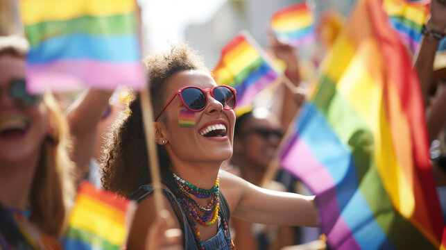 Gay pride parade, people celebrating gay pride outdoors with rainbow flag.