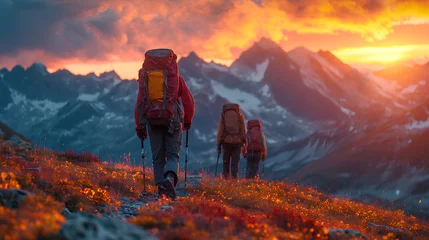 Foto op Plexiglas A group of hikers with backpacks treks towards the setting sun amidst the majestic mountains, embarking on an epic journey.  © wanchai