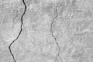 The wall of an old building with winding, deep cracks. Copy space. Black and white photo. Selective focus.