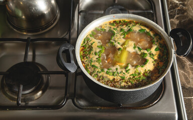 Cooking soup on a gas stove.