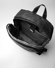 Fototapeta premium view inside an open black backpack on a white background