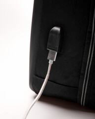 built-in USB port with a wire on a black backpack