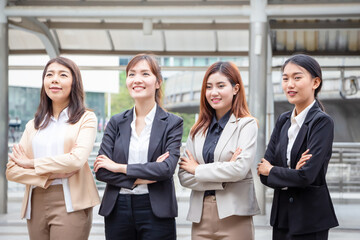 Business people standing with arms crossed, Young Asian women team standing with arms crossed blurred city background