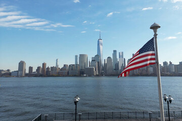 USA flag in NY. US American flag on NYC from drone. American Memorial, Veteran's Day, 4th of July. American Flag near New York City with Manhattan view. American Independence Day. Aerial View USA