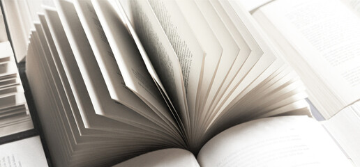stack of books, close up. Open book on the table in library. Back to school concept. Open book on table with blur bookshelf background