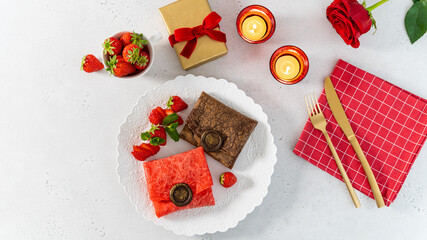 Pancakes in envelope shape with chocolate stamp and fresh strawberries for St. Valentine's day. Romantic breakfast recipe. Restaurant or cafe festive menu. Romantic dessert for 14 of February