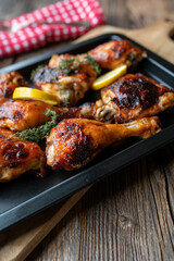 Chicken thighs and drumsticks with honey barbecue sauce on a baking tray