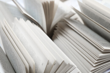 stack of books, close up. Open book on the table in library. Back to school concept. Open book on table with blur bookshelf background