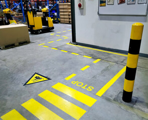 Walkway,footpath,Industrial building corridor painted yellow between parallel yellow lines on...