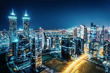 Fantastic view of a big city at night with illuminated modern architecture. Dubai downtown, United Arab Emirates.