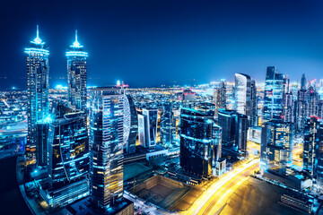 Fantastic view on a big city at night with illuminated modern architecture. Dubai downtown, United Arab Emirates.