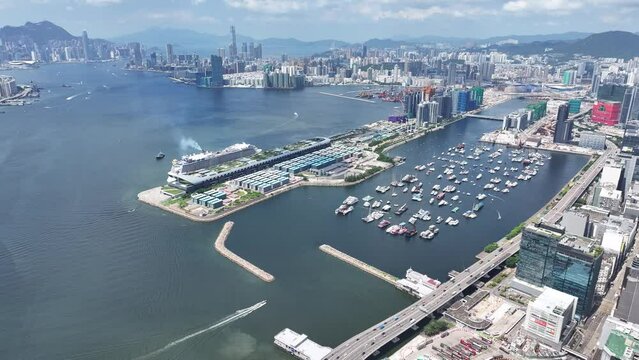 Drone Aerial Skyview of a Mega Luxury Cruise Ship is docking at the Kai Tak cruise terminal near Kai Tak Sports Park Kwun Tong Kowloon Victoria Harbour Hong Kong