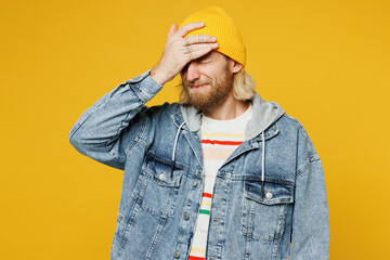 Young sad blond man he wear denim shirt hoody beanie hat casual clothes put hand on face facepalm...